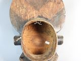 a wooden vase that is sitting on a white surface