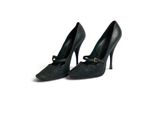 pair of black high heeled shoes on white background with copy space