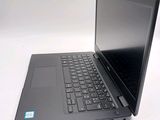 a laptop computer sitting on a white surface