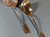 two spoons and a spoon rest on a gray surface