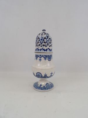 a small blue and white vase with a bird on it