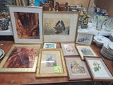 a table with a lot of framed pictures on it