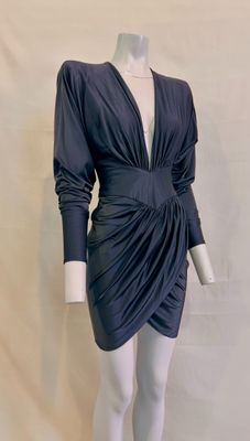 an image of a mannequin wearing a black dress with long sleeves