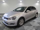 the silver volkswagen golf is parked in a large room