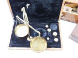 a small scale in a wooden case with buttons in it