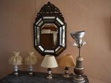 a table with a lamp and a mirror on it