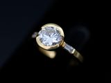 an image of a diamond ring on a black surface