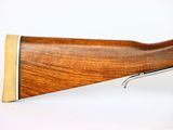a close up of a rifle on a white background with a pen
