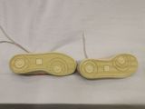 two pairs of yellow shoes are sitting on a white surface