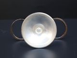 a close up of a silver object on a table