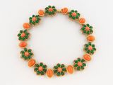 an image of a bracelet with green and orange stones on it