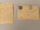 an old postcard with a handwritten letter on it next to a piece of paper with a stamp on it