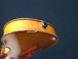 a violin that is being held up by a hand