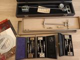 a box of tools sitting on a table next to a ruler and other items