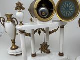 a clock on a stand with a clock in the middle of it