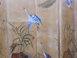 a room divider that has a painting of birds on it