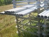 a bench made out of metal pipes in the grass