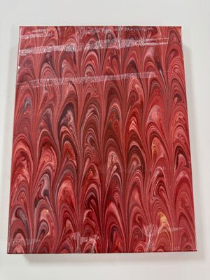 a close up of a piece of red marble on a white surface