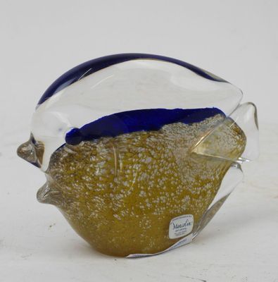 a glass fish that is sitting on a table