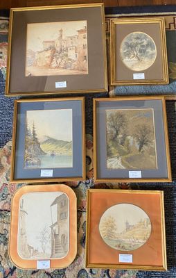 a lot of framed pictures on the floor of this room