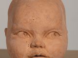 a clay head of a baby on a table
