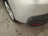 a close up of a car ' s bumper with a denting on it