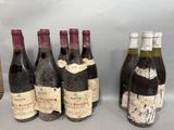 several bottles of wine are lined up on a table