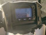 a close up of a motorcycle with a digital clock on it