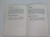 an open book on a white table with a black and white picture