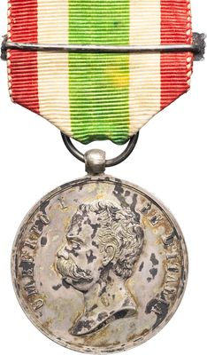 a close up of a medal with a red, white, and green ribbon