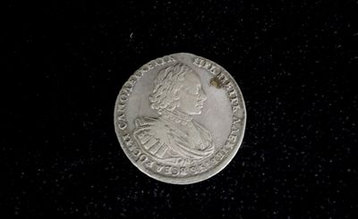 a silver coin with a picture of a man on it