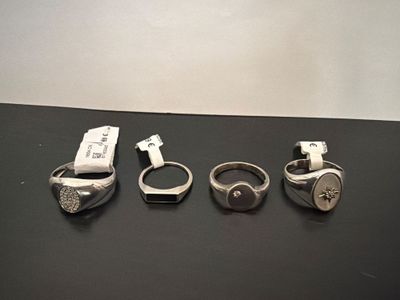 three rings and a cell phone sitting on top of a table