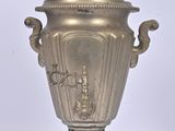 a silver urn that is sitting on a stand