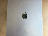an apple ipad sitting on top of a wooden table next to a cup of coffee