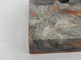a statue of a cat that is on a marble block