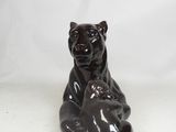 a black bear statue that is sitting on a white surface