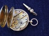a silver pocket watch with a chain attached to it