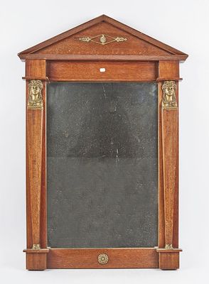 an old wooden mirror with a black glass in the middle of it