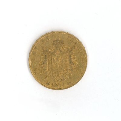 a close up of a gold coin on a white surface