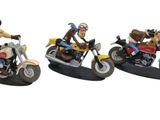 five figurines of people riding motorcycles on a white surface