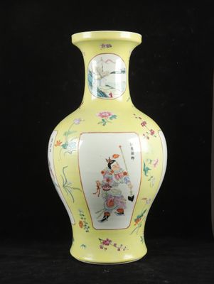 a yellow vase with a picture of a woman on it