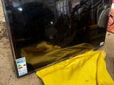 un téléviseur posé par terre à côté d'un tissu jaune