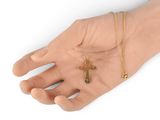 a hand that has a gold cross on it