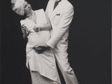an old black and white photo of a man and a woman dancing