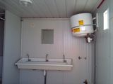 a bathroom with a sink and a water heater in it