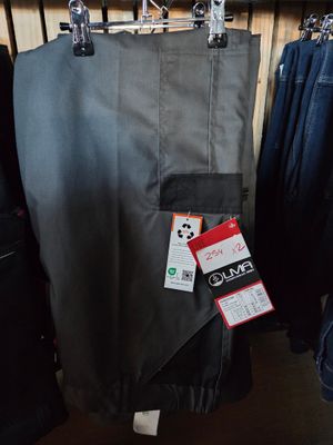 several pairs of jeans hanging on a rack in a clothing store