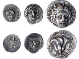 six ancient silver coins with faces and heads on them