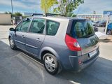 a small grey car parked in a parking lot