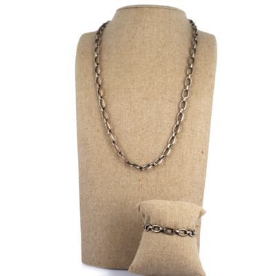 a close up of a mannequin with a chain and a pillow