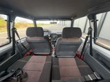 two seats in the back of a van with a view of the street